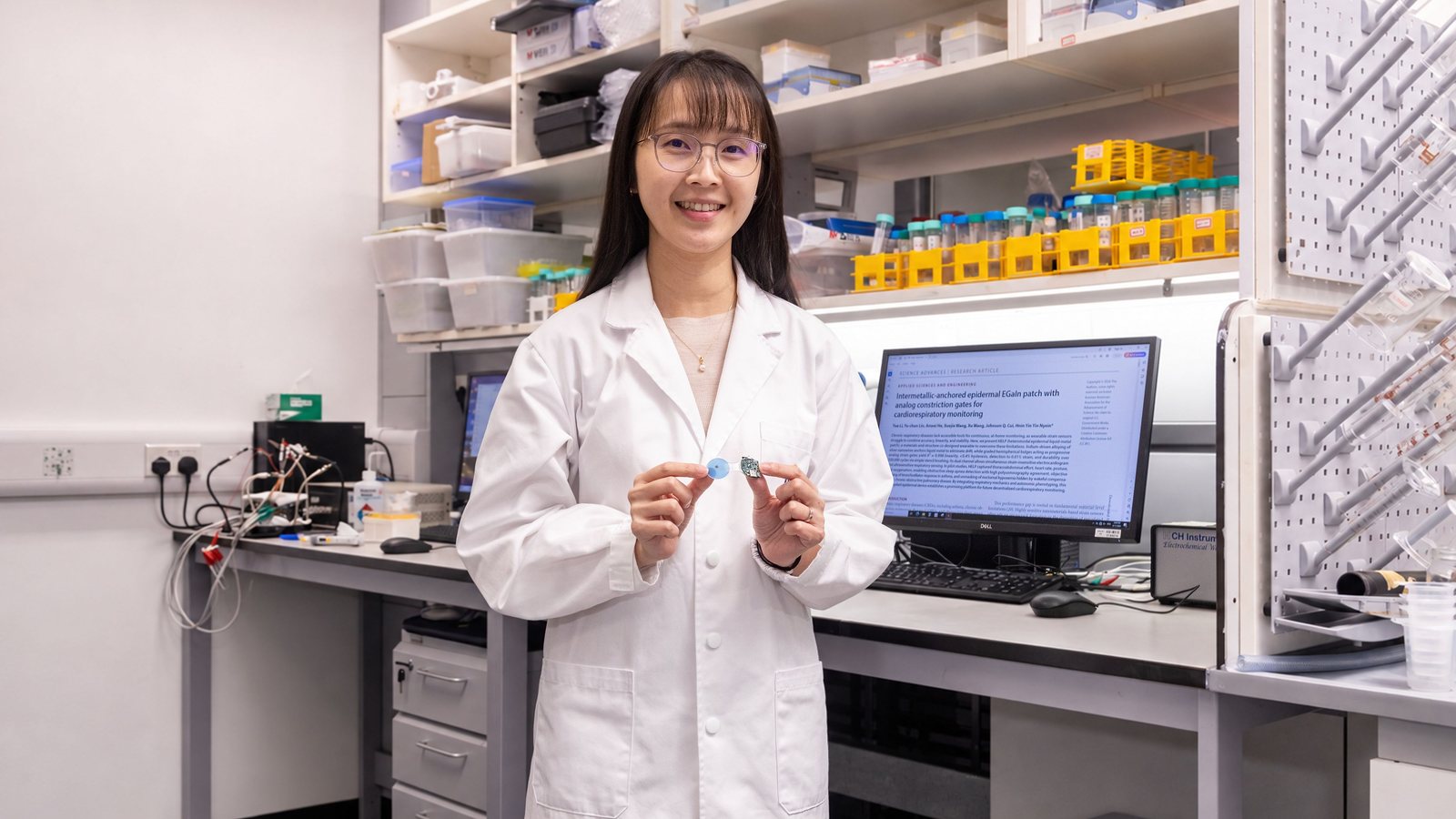 Prof. Hnin Yin Yin Nyein in her HKUST laboratory holding up the small, flexible HELP liquid-metal patch